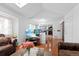 Open-concept living room with hardwood floors, a vaulted ceiling and a view to the kitchen at 18982 E 46Th Ave, Denver, CO 80249