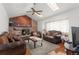Comfortable living room features a brick fireplace and vaulted ceiling at 18982 E 46Th Ave, Denver, CO 80249