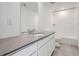 Bathroom with a combined shower and tub, white tiling, and a vanity at 7171 Waterleaf Trl, Littleton, CO 80125