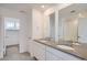 Bathroom featuring a double sink vanity, walk-in shower, and neutral tile flooring at 7171 Waterleaf Trl, Littleton, CO 80125