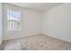 Bright bedroom with carpet, white walls, and large window offers a serene and inviting space at 7171 Waterleaf Trl, Littleton, CO 80125