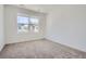 Bright bedroom with neutral carpet and a large window offering neighborhood views at 7171 Waterleaf Trl, Littleton, CO 80125