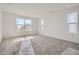 Bright bedroom with carpet, white walls, and large windows offers a serene and inviting space at 7171 Waterleaf Trl, Littleton, CO 80125