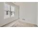 Bright bedroom with carpet, white walls, and large window offers a serene and inviting space at 7171 Waterleaf Trl, Littleton, CO 80125