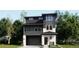 Modern two-story home with a gray and white color scheme, balcony, and an integrated two-car garage at 7171 Waterleaf Trl, Littleton, CO 80125