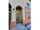 Front entrance to a townhome with brick accents and arched entry at 230 Poplar St # B, Denver, CO 80220