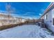 Snow-covered backyard with wooden fence and AC unit at 5780 Raleigh Cir, Castle Rock, CO 80104