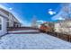 Snow-covered backyard with wooden fence and deck at 5780 Raleigh Cir, Castle Rock, CO 80104