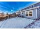 Spacious backyard with snow and wooden fence at 5780 Raleigh Cir, Castle Rock, CO 80104