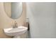 Small bathroom with pedestal sink and oval mirror at 5780 Raleigh Cir, Castle Rock, CO 80104