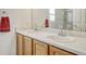 Bathroom with double sinks and wood cabinets at 5780 Raleigh Cir, Castle Rock, CO 80104