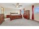Spacious bedroom with a wooden bed frame and ceiling fan at 5780 Raleigh Cir, Castle Rock, CO 80104