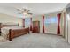 Spacious bedroom with a wooden bed frame and ceiling fan at 5780 Raleigh Cir, Castle Rock, CO 80104