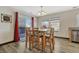 Dining area with glass-top table, wood chairs, and red curtains at 5780 Raleigh Cir, Castle Rock, CO 80104