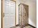 Entryway with a rustic wood cabinet and white door at 5780 Raleigh Cir, Castle Rock, CO 80104