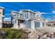 Two-story house with blue siding, stone accents, and a two-car garage at 5780 Raleigh Cir, Castle Rock, CO 80104