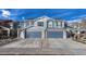 Two-story house with blue siding, stone accents, and a three-car garage at 5780 Raleigh Cir, Castle Rock, CO 80104