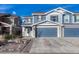 Two-story house with blue siding, stone accents, and a two-car garage at 5780 Raleigh Cir, Castle Rock, CO 80104