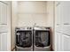 Bright laundry room, featuring a washer and dryer at 5780 Raleigh Cir, Castle Rock, CO 80104