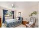Cozy bedroom with a ceiling fan and view of the backyard at 3317 S Elkhart St, Aurora, CO 80014