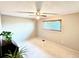 Bright bedroom featuring neutral walls, ceiling fan, and carpeted floors at 3317 S Elkhart St, Aurora, CO 80014