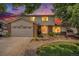 Attractive two-story home showcasing curb appeal at dusk at 3317 S Elkhart St, Aurora, CO 80014