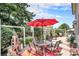 Inviting patio with seating area, red umbrella, and lush landscaping at 3317 S Elkhart St, Aurora, CO 80014