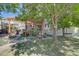 Inviting back patio and backyard with pergola, patio furniture, and lush greenery, perfect for outdoor entertaining and relaxation at 23500 Bent Oaks Way, Parker, CO 80138