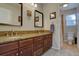 Bathroom with a double sink vanity with granite countertop and cabinets at 23500 Bent Oaks Way, Parker, CO 80138