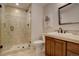 A renovated bathroom features a tiled shower with glass door and a vanity with a granite countertop at 23500 Bent Oaks Way, Parker, CO 80138