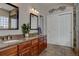 Bathroom featuring double sink vanity, granite countertops, and closet space at 23500 Bent Oaks Way, Parker, CO 80138