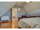 This bedroom features hardwood floors, an angled ceiling, and an adjoining doorway at 23500 Bent Oaks Way, Parker, CO 80138