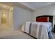 A bedroom with carpet features an ensuite bathroom with tile shower behind a glass door at 23500 Bent Oaks Way, Parker, CO 80138