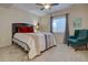 Cozy bedroom with carpet, a ceiling fan, a window with curtains, and a plush armchair at 23500 Bent Oaks Way, Parker, CO 80138