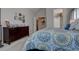 Bedroom features a dresser and doorway leading to the ensuite bathroom at 23500 Bent Oaks Way, Parker, CO 80138