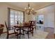 Cozy dining room featuring hardwood floors, shuttered window and an elegant chandelier at 23500 Bent Oaks Way, Parker, CO 80138