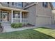 Welcoming covered front porch showcasing classic white railing, brick accents, and manicured landscaping at 23500 Bent Oaks Way, Parker, CO 80138