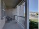 Inviting front porch featuring a wicker chair, white railing, brick exterior, and neighborhood views at 23500 Bent Oaks Way, Parker, CO 80138