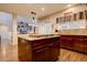 Kitchen island with built-in stovetop, cabinetry and view into the living room at 23500 Bent Oaks Way, Parker, CO 80138