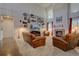 Bright living room featuring a fireplace, large windows and comfortable seating at 23500 Bent Oaks Way, Parker, CO 80138