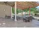 Covered patio with stone flooring, pergola, outdoor seating around a fire pit, and a manicured garden at 23500 Bent Oaks Way, Parker, CO 80138