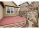 Exterior shot of a red wood deck, door and window on a tan house at 4363 W 118Th Way, Westminster, CO 80031