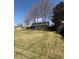 Two-story home featuring a covered back deck, mature trees and a grass yard at 7055 S Costilla St, Littleton, CO 80120