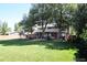 Expansive backyard with lush green grass and shaded patio at 7055 S Costilla St, Littleton, CO 80120