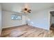 Bright bedroom featuring natural light, hardwood floors, and ample closet space at 7055 S Costilla St, Littleton, CO 80120