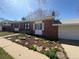 Exterior of a charming red-brick home with white trim and a well-manicured front yard at 7055 S Costilla St, Littleton, CO 80120