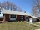 Charming brick home with a well-maintained front yard and a 'For Sale' sign at 7055 S Costilla St, Littleton, CO 80120