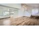 Open-concept living space with hardwood floors and a view of the staircase at 7055 S Costilla St, Littleton, CO 80120