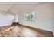 Bright living room featuring large windows, updated flooring, and stair access at 7055 S Costilla St, Littleton, CO 80120