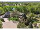 Stunning aerial view of a landscaped home nestled amongst lush trees and landscaping near a pond at 6862 Independence Ct, Arvada, CO 80004